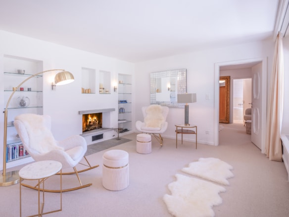 Heller Wohnbereich mit Cheminée und Sesseln, Wohnung in St. Moritz